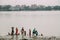 Indian people take a bath and clean themselves by using water from a Hooghly River near Mullick Ghat Flower Market in Kolkata.