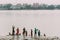 Indian people take a bath and clean themselves by using water from a Hooghly River near Mullick Ghat Flower Market in Kolkata