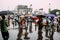 Indian people walking in the rain with umbrella near the area of Howrah Junction railway station