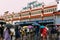 Indian people walking in the rain with umbrella near the area of Howrah Junction railway station at Kolkata, India