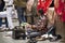 Indian people working and wait polishing leather shoes of foreign businessman at Janpath and Tibetan Market and Dilli Haat bazaar