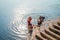 Indian Pilgrim doing his morning prayers in the river Ganges in Varanasi uttar pradesh India