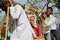 Indian pilgrims carried on primitive sedan chairs