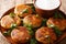 Indian potato patties Aloo Tikki served with yogurt close up in a dish. horizontal