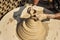 Indian potter making clay pots on pottery wheel in Bikaner. India