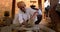 Indian potter at work throwing the potter\'s wheel and shaping clay ware: pot, jar in pottery workshop. Rajasthan