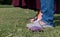 Indian pregnant lady with husband posing in park with baby shoes