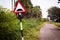 Indian road cautionary sign indicating speed breaker ahead. Sign indicating to slowdown as speed bump in road