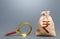 Indian rupee money bag and magnifying glass. Find high-paying job. Most favorable conditions for deposits, loans. Origin