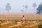 Indian rural woman standing in the mist