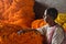 Indian seller with flower garland on Flower market at Mallick Ghat in Kolkata. India