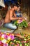 Indian seller makes basket of flowers on Flower market at Mallick Ghat in Kolkata. India