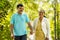 indian senior couple walking by talking each other at park - concept of relationship, relaxation and retirement