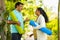 Indian senior couple with yoga mat talking each other during morning at park - concept of relaxation, fitness and