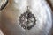 Indian Shiva Nataraja symbol pendant jewelry on pearly white shell background