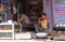 An Indian shop owner selling street food in a street in Pushkar, India