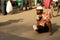 Indian sick beggar seeking help on a busy road.