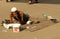 Indian sick beggar seeking help on a busy road.