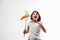 Indian small girl and tricolour face holding windmill made up of saffron, green and white colour paper, happy independence or repu