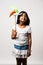 Indian small girl and tricolour face holding windmill made up of saffron, green and white colour paper, happy independence or repu