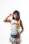 Indian small girl and tricolour face holding windmill made up of saffron, green and white colour paper, happy independence or repu