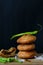 Indian snack kachori served with green chilli and onions in a black background