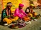 An Indian Snake charmer wearing a turban charms or hypnotizes a cobra using pungi flute at Assi ghat
