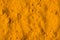 Indian spice turmeric. Close up view photo of textured backdrop of light color curcuma powder