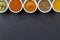 Indian spices in little white bowls on black background - top view photo