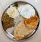 Indian spicy food including puri,roti,bharit,papad,chatani thali