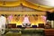 Indian stage decoration with multi color flowers, props and lights