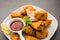 indian starter chicken pakora or pakoda or fritter served with tomato ketchup