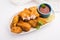 indian starter chicken pakora or pakoda or fritter served with tomato ketchup