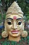 Indian staue of gilded head with third eye chakra