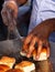 Indian street food vendor making pav baji or vada pav