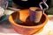 Indian street food vendor making tandoori masala chai tea by boiling in a hot clay pot in brass pot to boil the tea