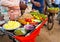 Indian street food vendor selling spicy gram chole mixture garnished with freshly cut onion,cucumber chilli and tomatoindian