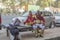 Indian street performers musicians with drums in red dress uniform are resting on the bench
