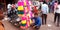 an indian street seller seating horizontal for sale at market in India Oct 2019