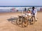 An Indian street vendor pushing his wheeled cart on the beach