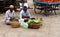 Indian street vendors sell beetle leaves in a market place