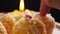 Indian sweet Motichoor Laddoo or Bundi Laddu. Coconut sweet Laddoo on black background, blurry candle in the background.