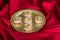 Indian sweets in an artistic metal plate in satin red table cloth