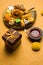 Indian sweets or Mithai for diwali festival with oil lamp or diya and gift box