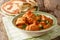 Indian traditional Karhai chicken recipe in thick tomato sauce close up and naan. horizontal