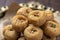 Indian traditional sweet balushahi served on a metal plate on wooden background