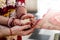 Indian traditional wedding. authentic Vedic wedding ritual called vivaha Yajna. Red Sari, women hands with mehendi close