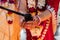 Indian traditional wedding. authentic Vedic wedding ritual called vivaha Yajna. Red Sari, women hands with mehendi close