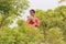 An Indian traditional woman holding a teddy bear and posing in the field