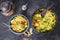 Indian Vegetable Biryani with Sweet Pepers and Zucchini offered in a frying pan and bowl